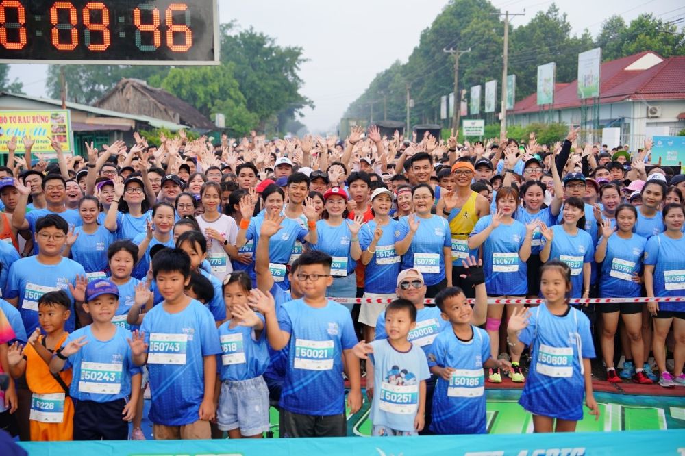 A group of people in blue shirtsDescription automatically generated